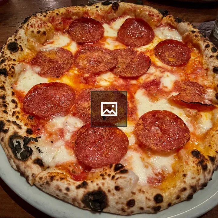 Pepperoni pizza in wood-fired oven