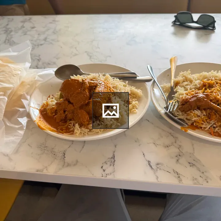 Two plates of rice with chicken