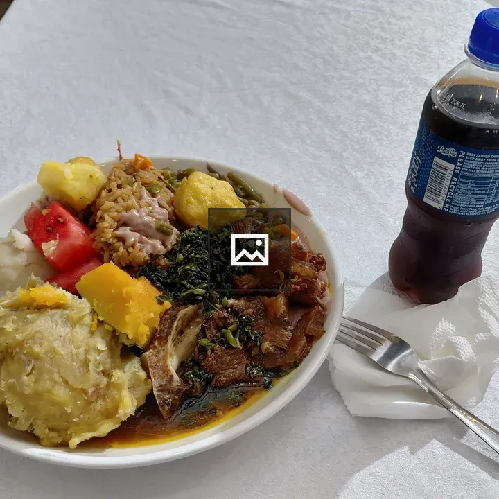 Plate of mixed food with rice and greens