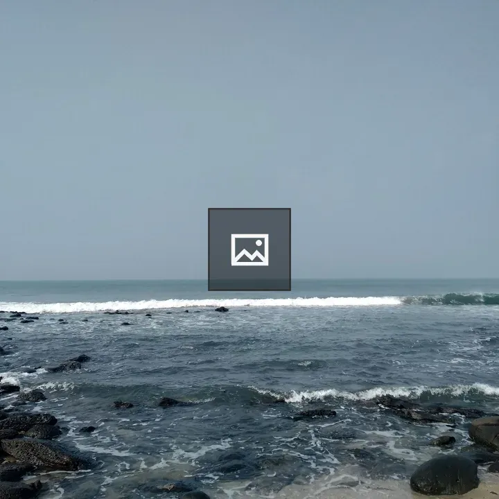 Rocky shore with blue ocean and sky