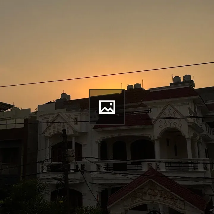 Silhouette of two-story house at sunset