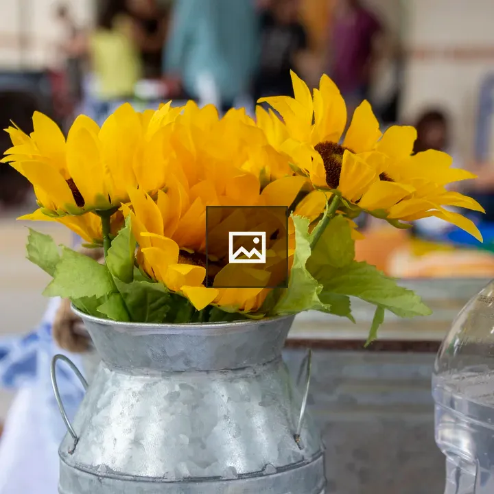 Fake sunflowers in an aluminum vase