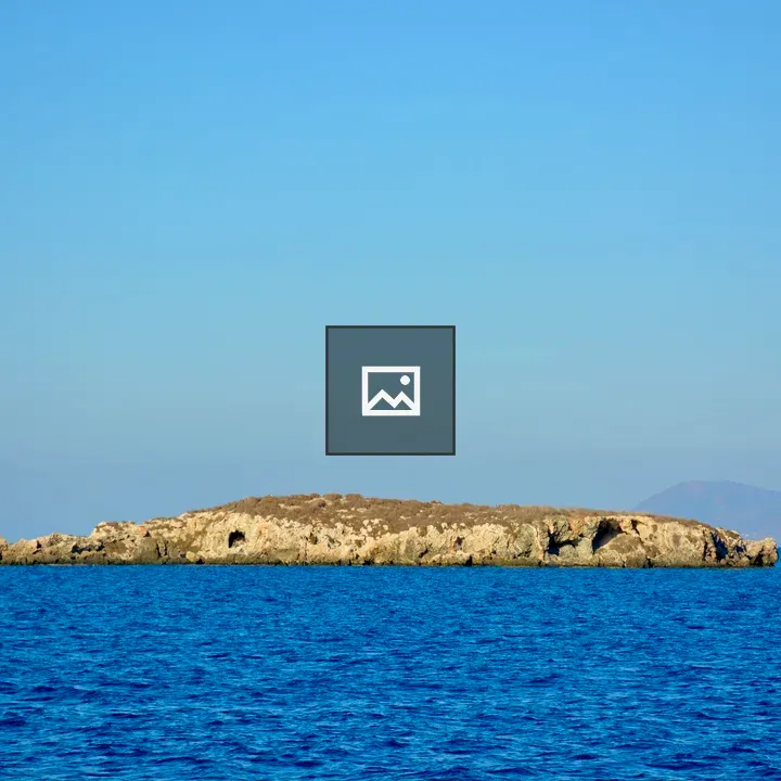 Rocky island in blue waters