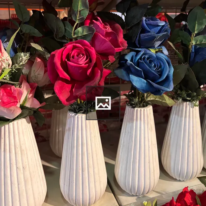 White ceramic vases with artificial roses