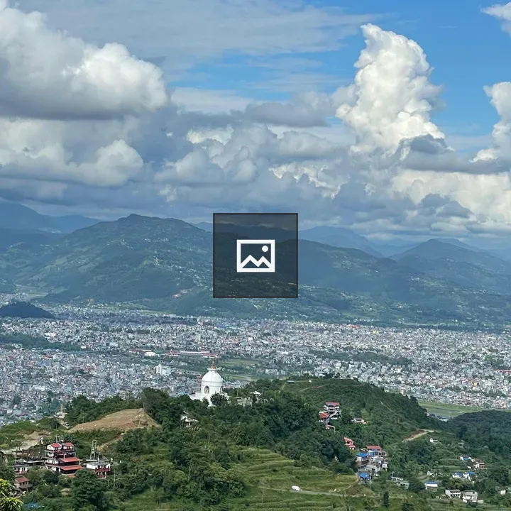 Stupa on a terraced hill with mountains