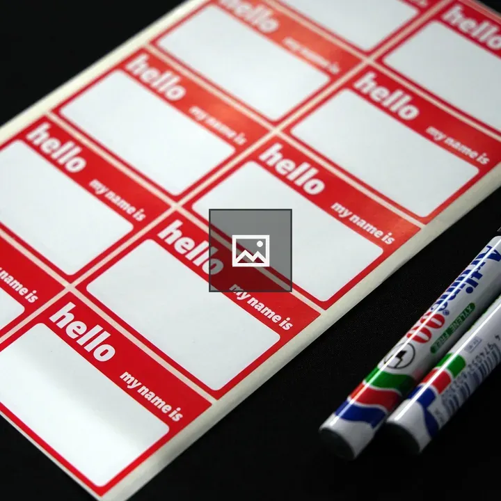 Greeting name tags on black surface