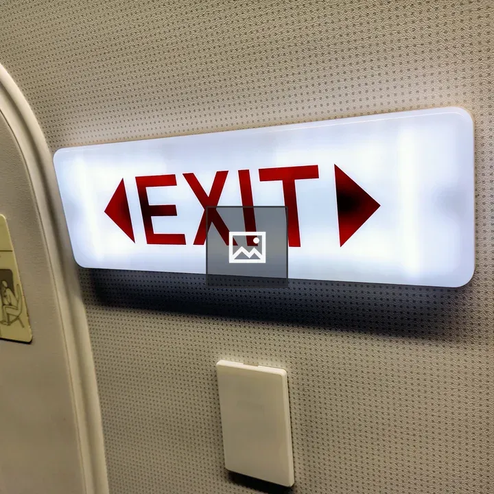Illuminated exit sign on airplane door
