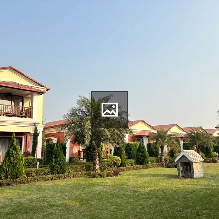 Landscaped area with red-tiled homes