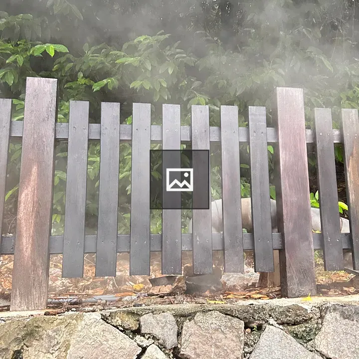 Wooden Fence in Green Hedge