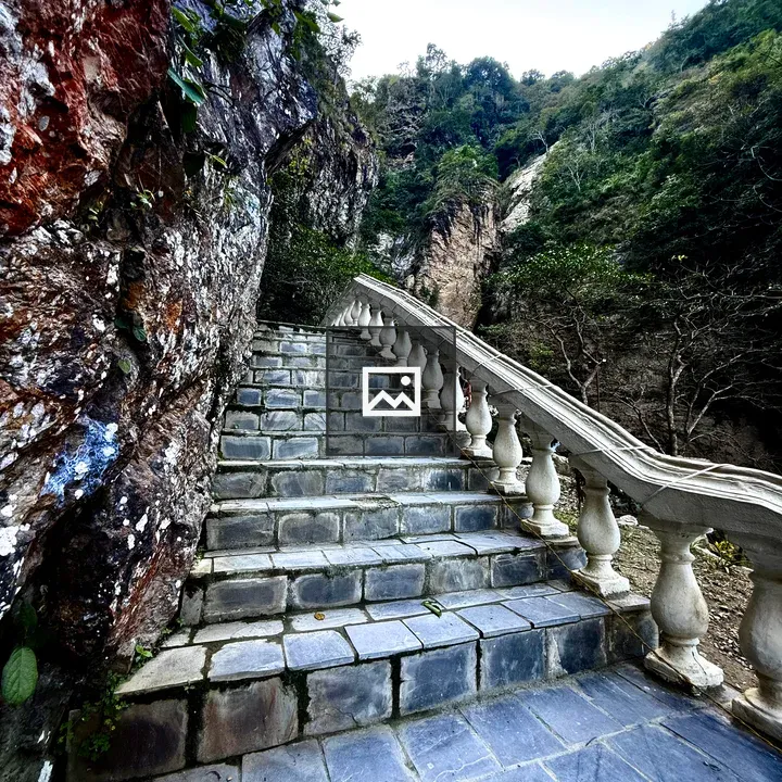 Stone staircase by rocky cliff