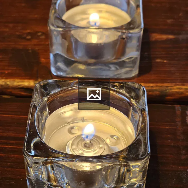 Two tealight candles in glass holders