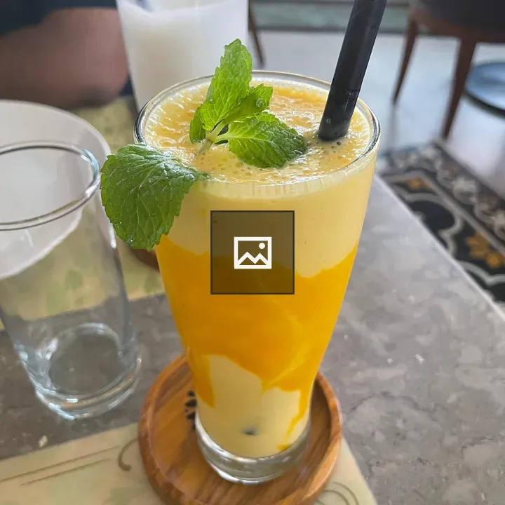 Yellow smoothie in glass