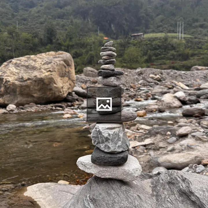 Stacked stones by riverbed