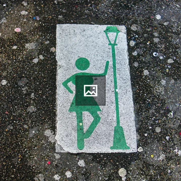 Green silhouette symbol on pavement