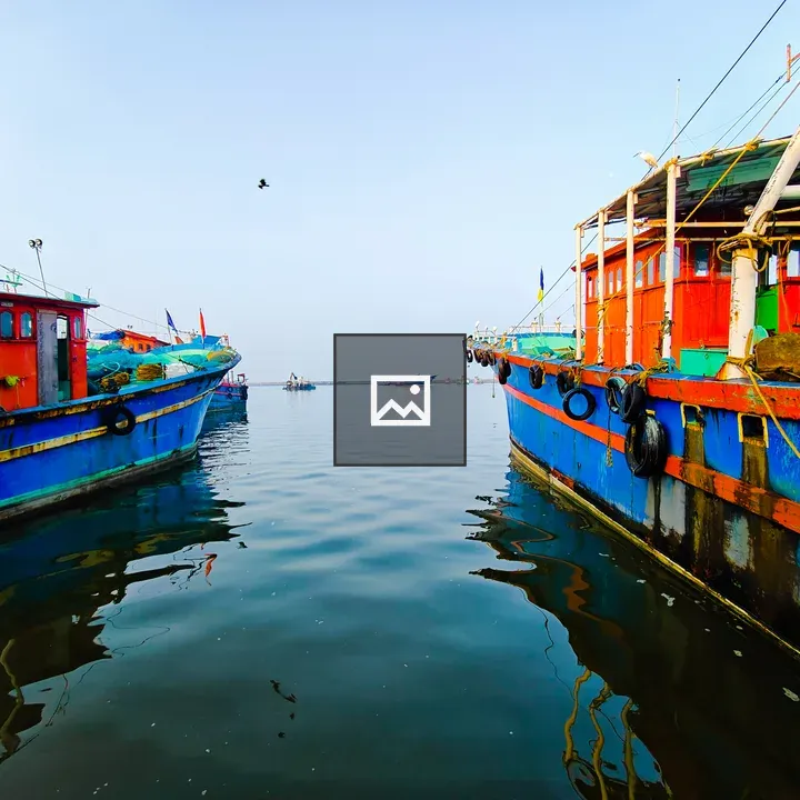 Red and blue boats on shore