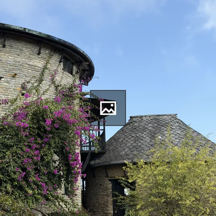 Stone round buildings with slate roofs