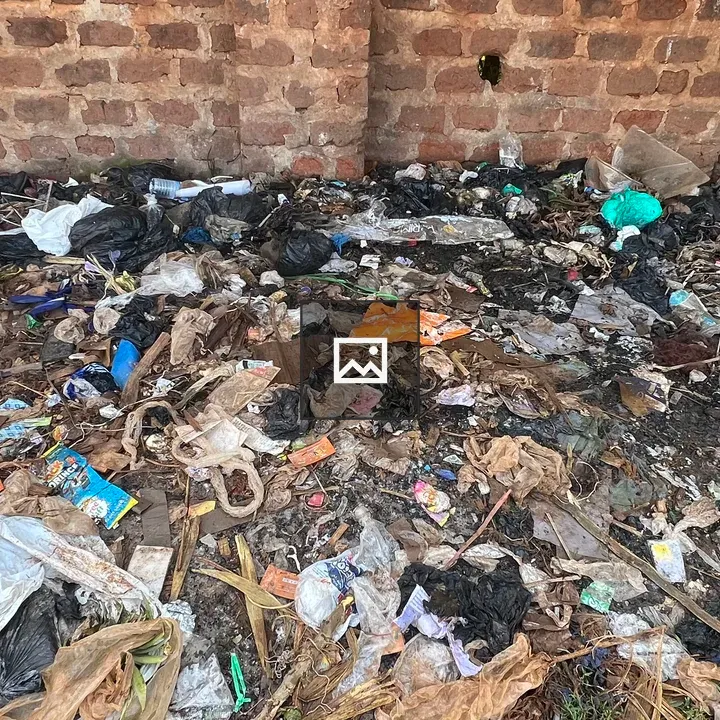 Pile of mixed garbage near brick wall