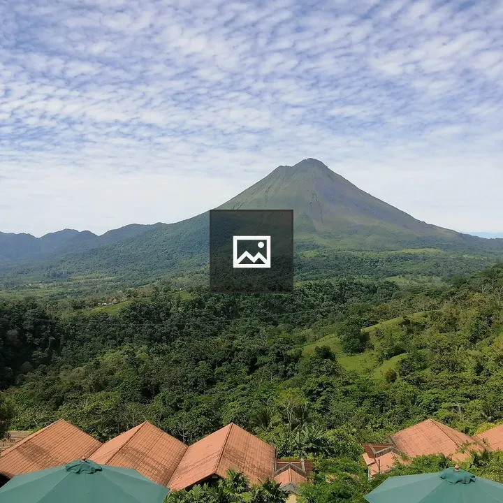 Volcano Over Green Hills and Rooftops