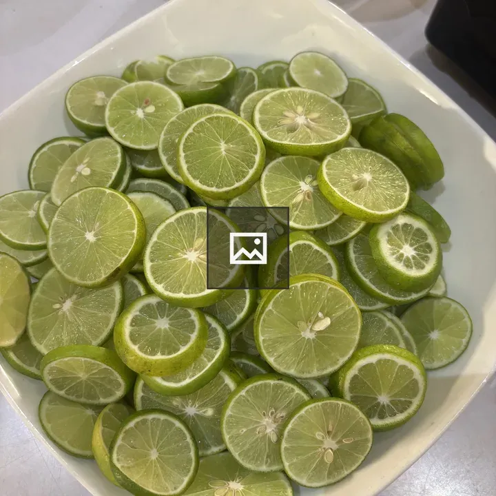 Lime slices in white bowl