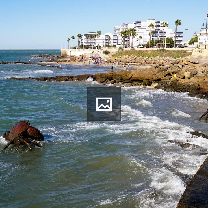 Rocky shoreline with crab sculptures
