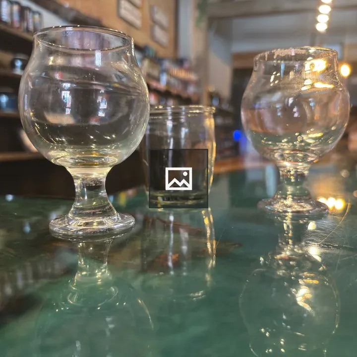 Tulip glasses and barware on a counter