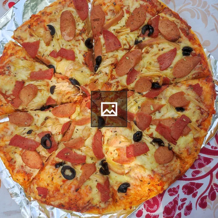 Pizza topped with cheese and sausage
