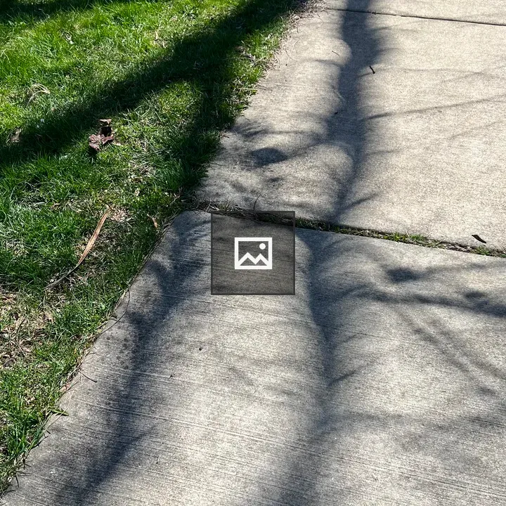 Solar eclipse shadow on sidewalk