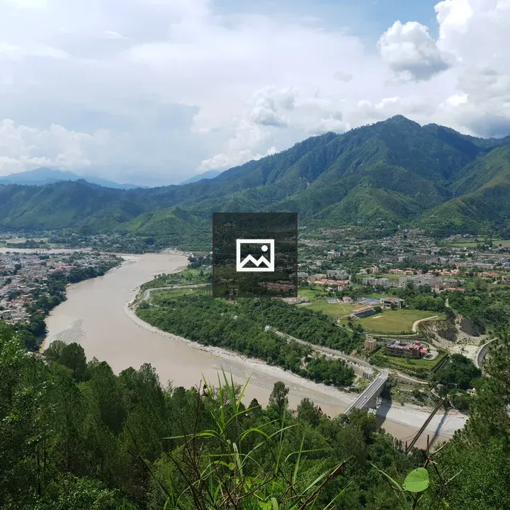 Mud River Between Houses and Mountains