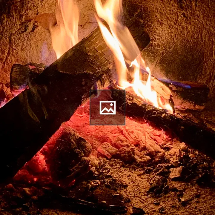 Two logs burning in a fireplace