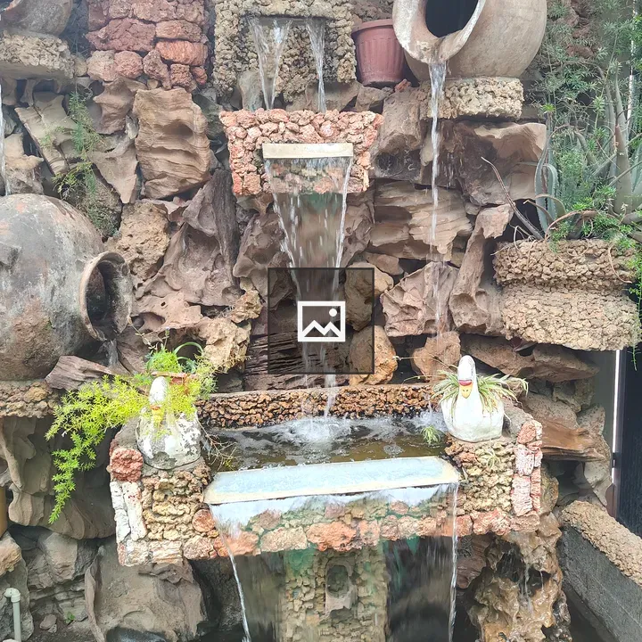 Decorative fountain with rocks and pots