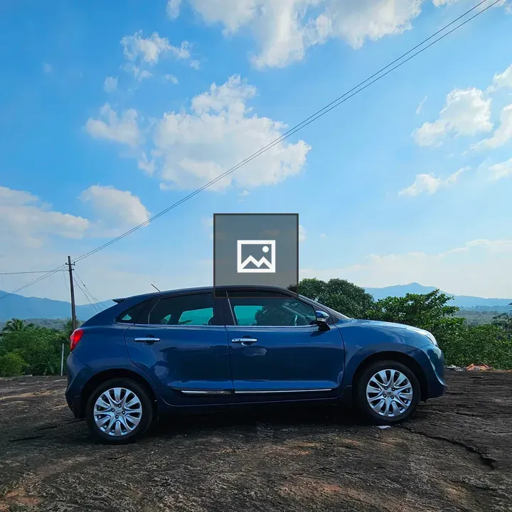 Blue car on rocky hill