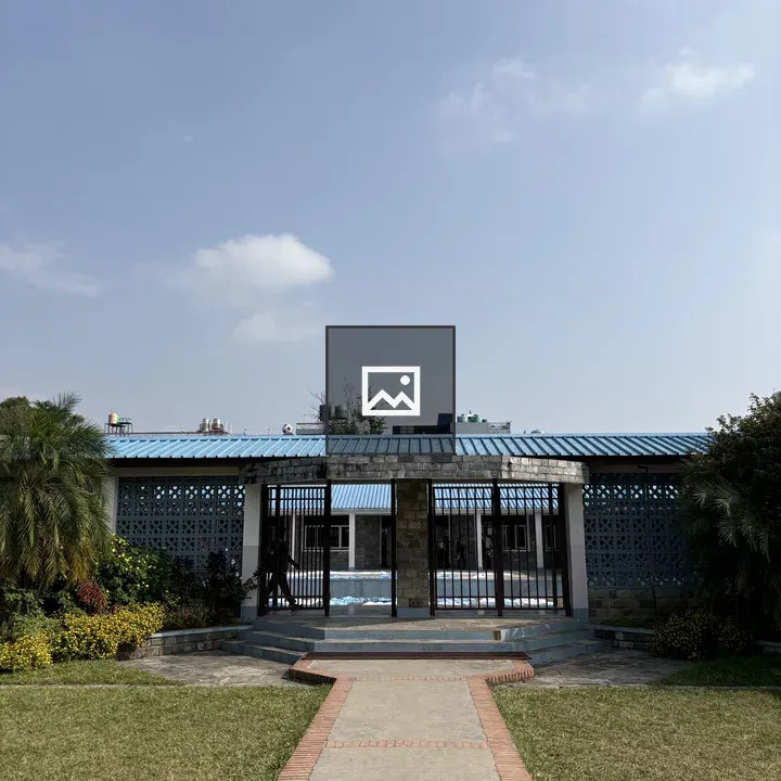 Stone Path to Blue Roof Building