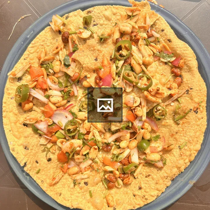 Cracker topped with vegetables and peanuts