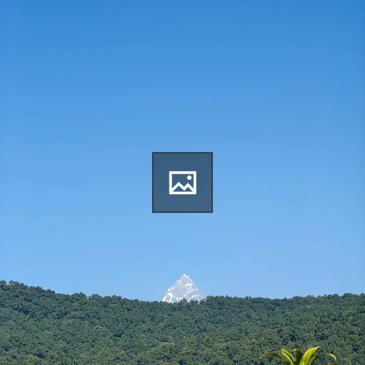 Snow-capped Peak Over Green Hills