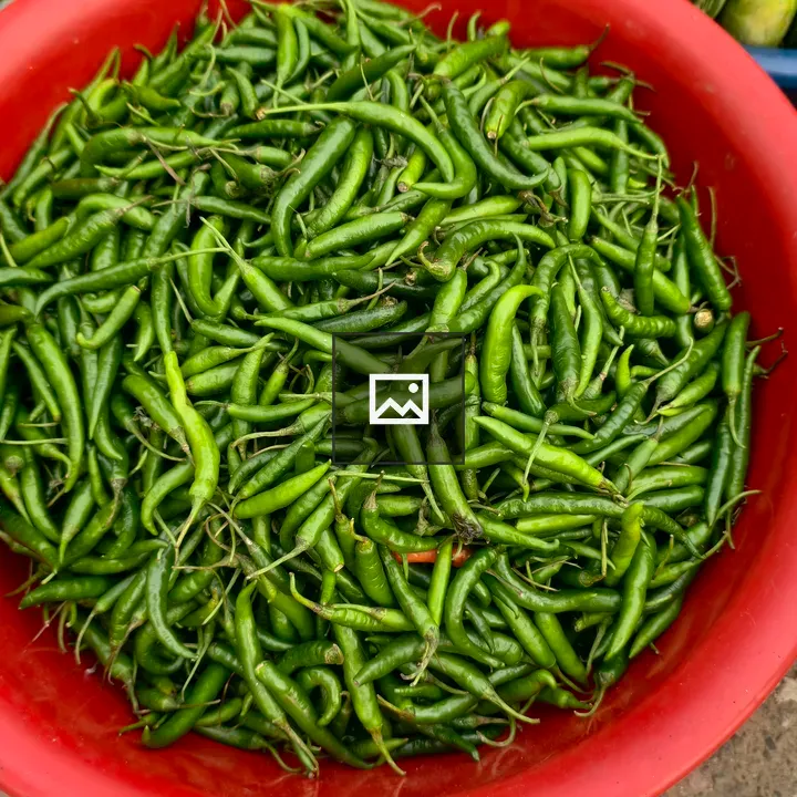 Red bowl with green chili peppers
