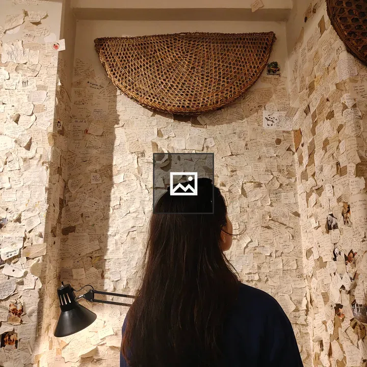 Person in a notes-covered room
