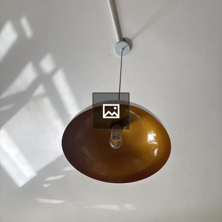 Amber pendant light over white ceiling