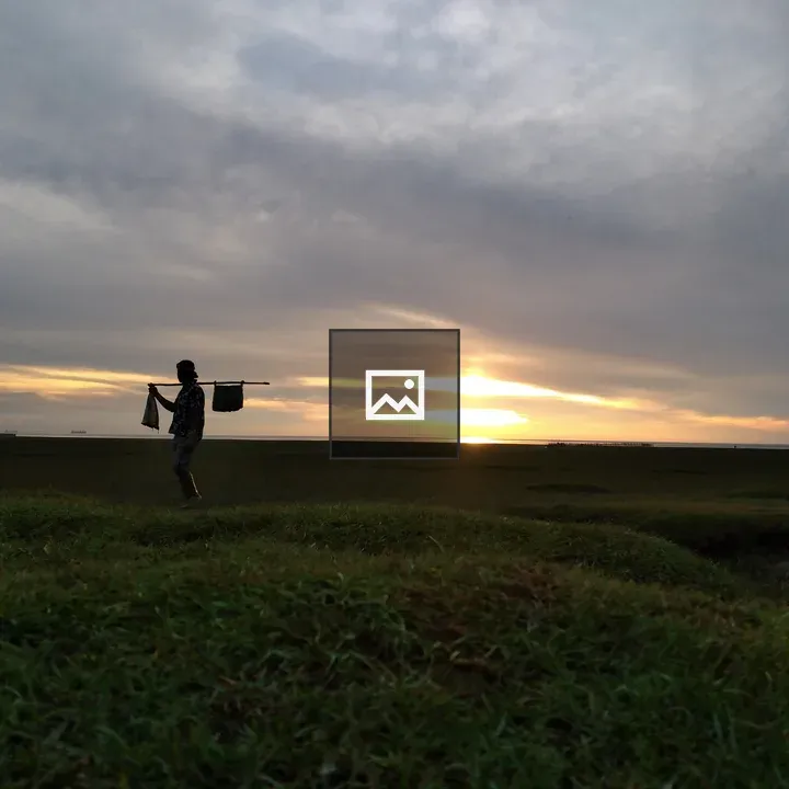 Silhouette of a Person Walking at Sunset