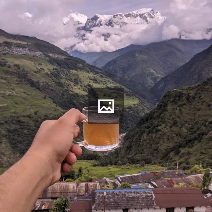 Hand holding a glass of tea