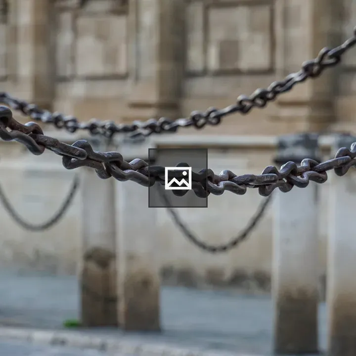 Close-up of metal chains between pillars