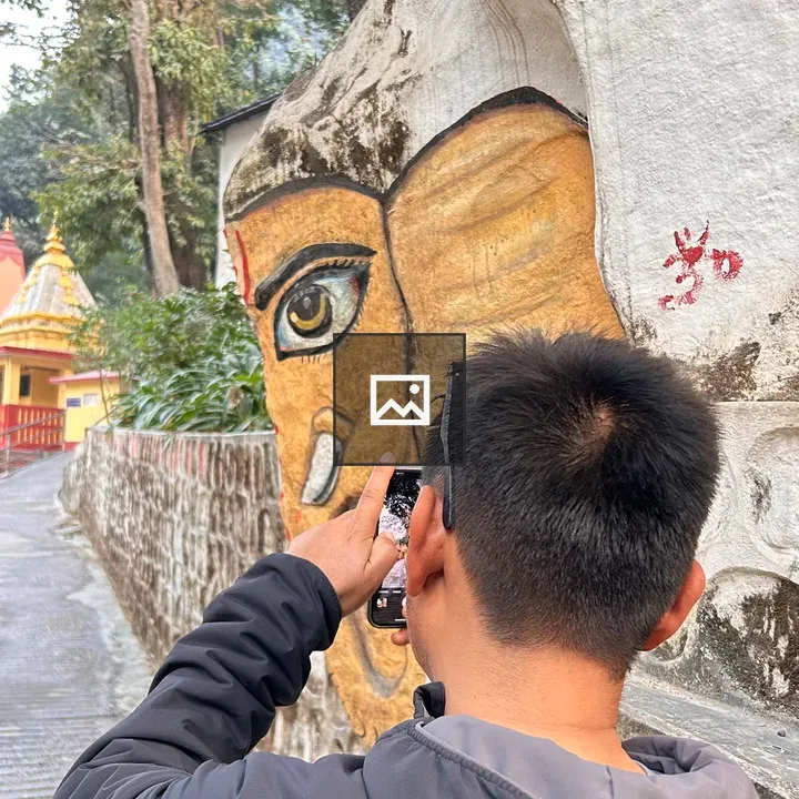 Person on Pathway by Painted Rock Wall