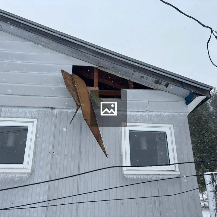 Side of House with Damaged Siding