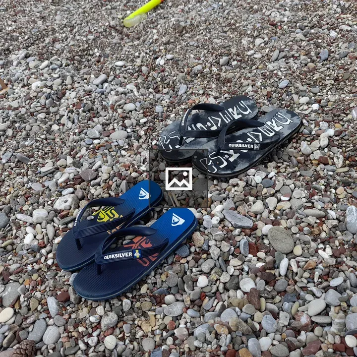Sandals on Pebbles by Water