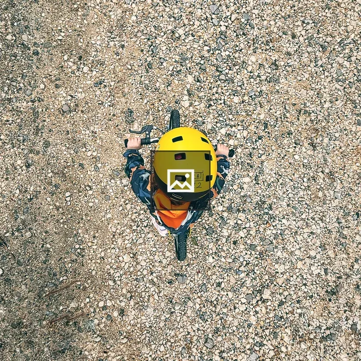 Kid on bike with yellow helmet