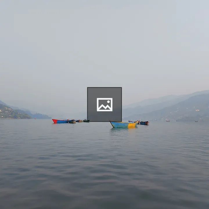 Calm lake with colorful boats
