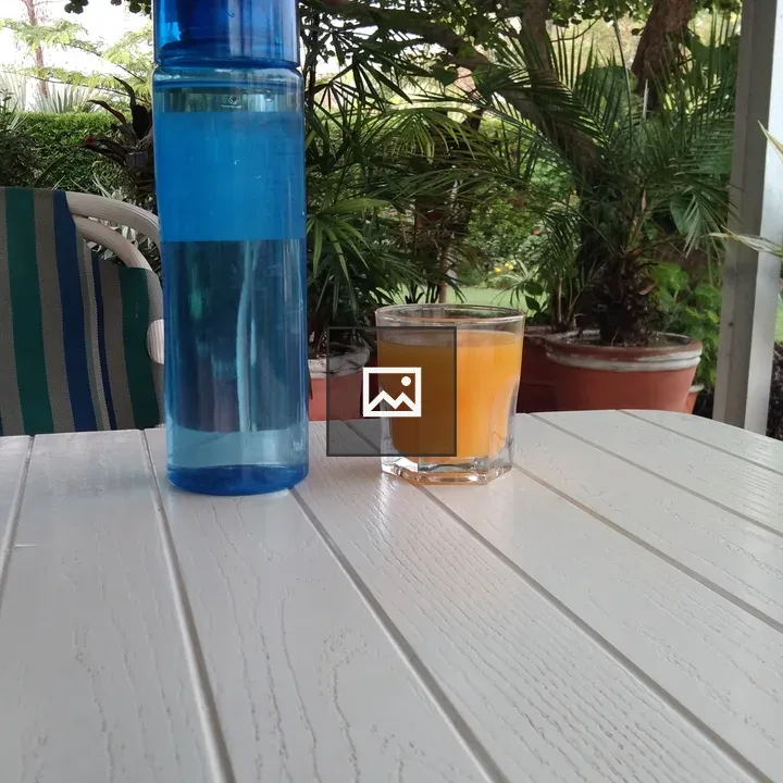 Blue water bottle on white table