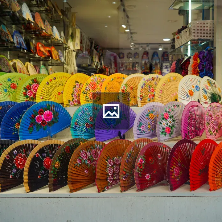 Rainbow-colored fans in window