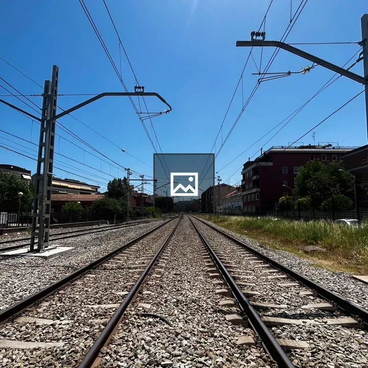 Railway tracks under blue sky
