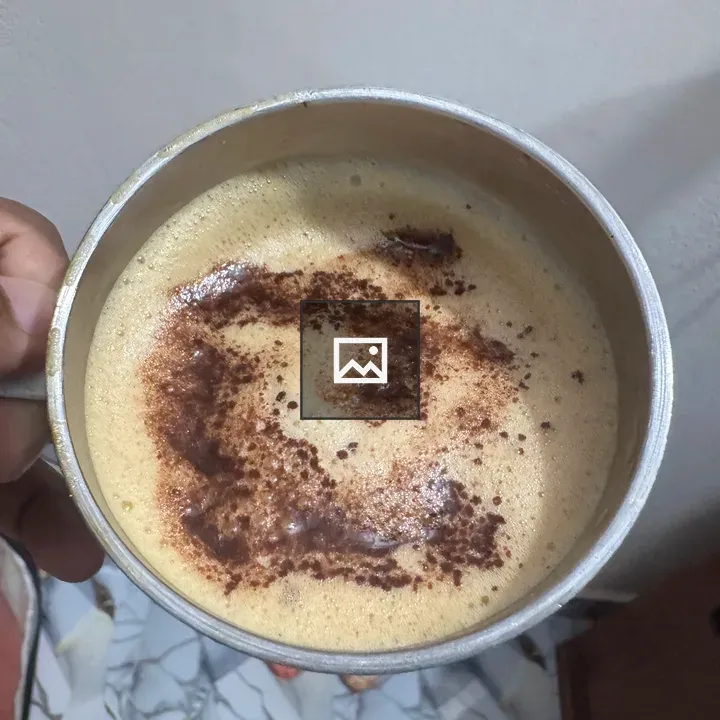 Hand holding mug of coffee