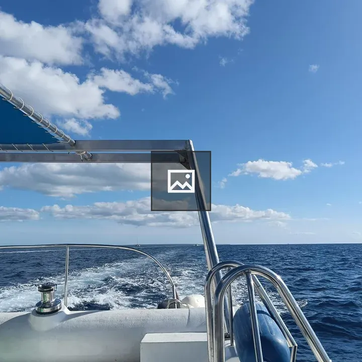 Rear deck view of white boat on blue ocean
